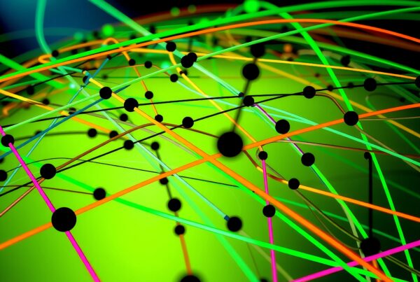 Abstract colorful network with intricate lines and dots against a green background.