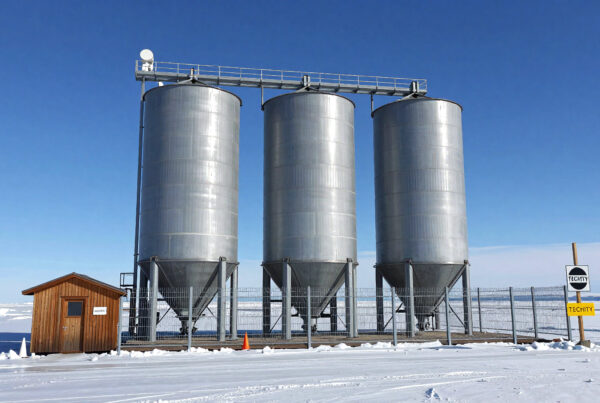 Antarctic industrial silo complex surrounded by snowscape