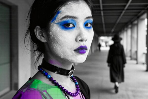Woman with vibrant makeup in a black and white urban setting.