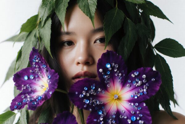 A woman's portrait surrounded by green leaves and gem-studded purple flowers, exuding tranquility and natural beauty.