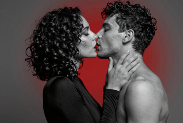 Intimate romantic couple kissing under dramatic red light photography portrait