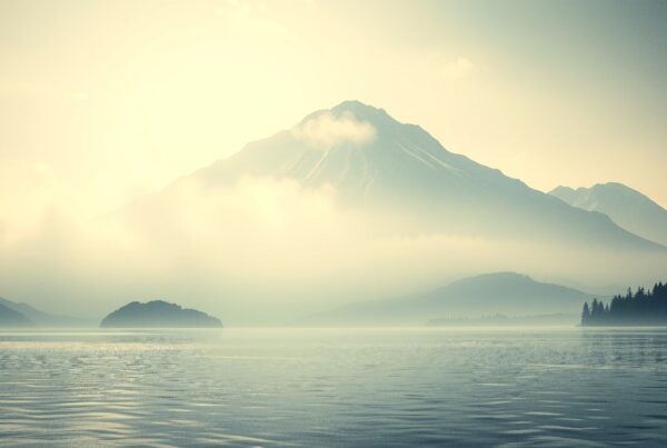 Tranquil mountain scene with misty lake.