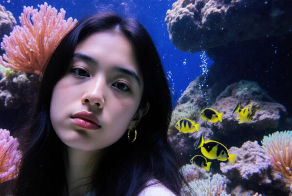 Young woman in an underwater scene with coral and fish.