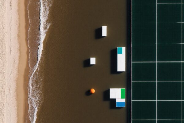 Aerial view of a beach with geometric structures and a sports court.