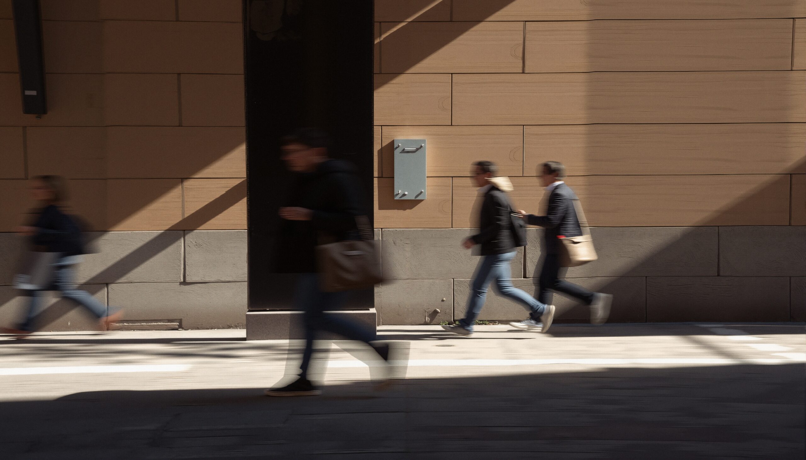 Pedestrians and Shadows on Wall