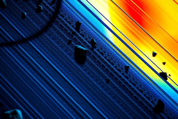 Vivid abstract space scene with colorful planetary rings and asteroids.