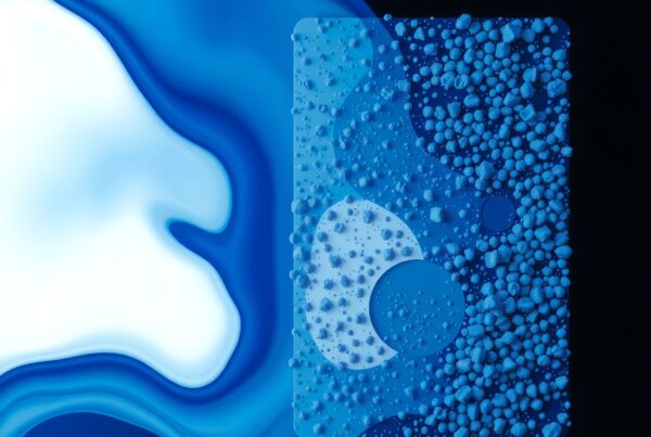 Abstract image with blue and white hues, featuring textured spheres and fluid patterns.