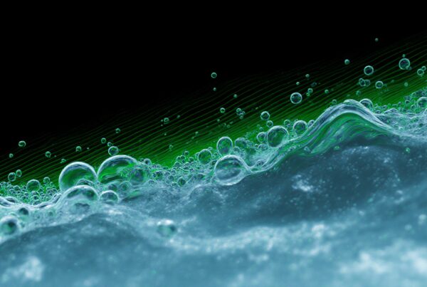 An abstract image of translucent bubbles with green hues on a dark background.