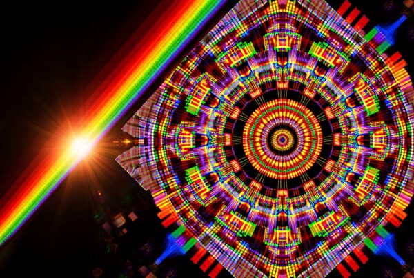 A vibrant digital artwork featuring geometric patterns and a diagonal rainbow beam with a sunburst.
