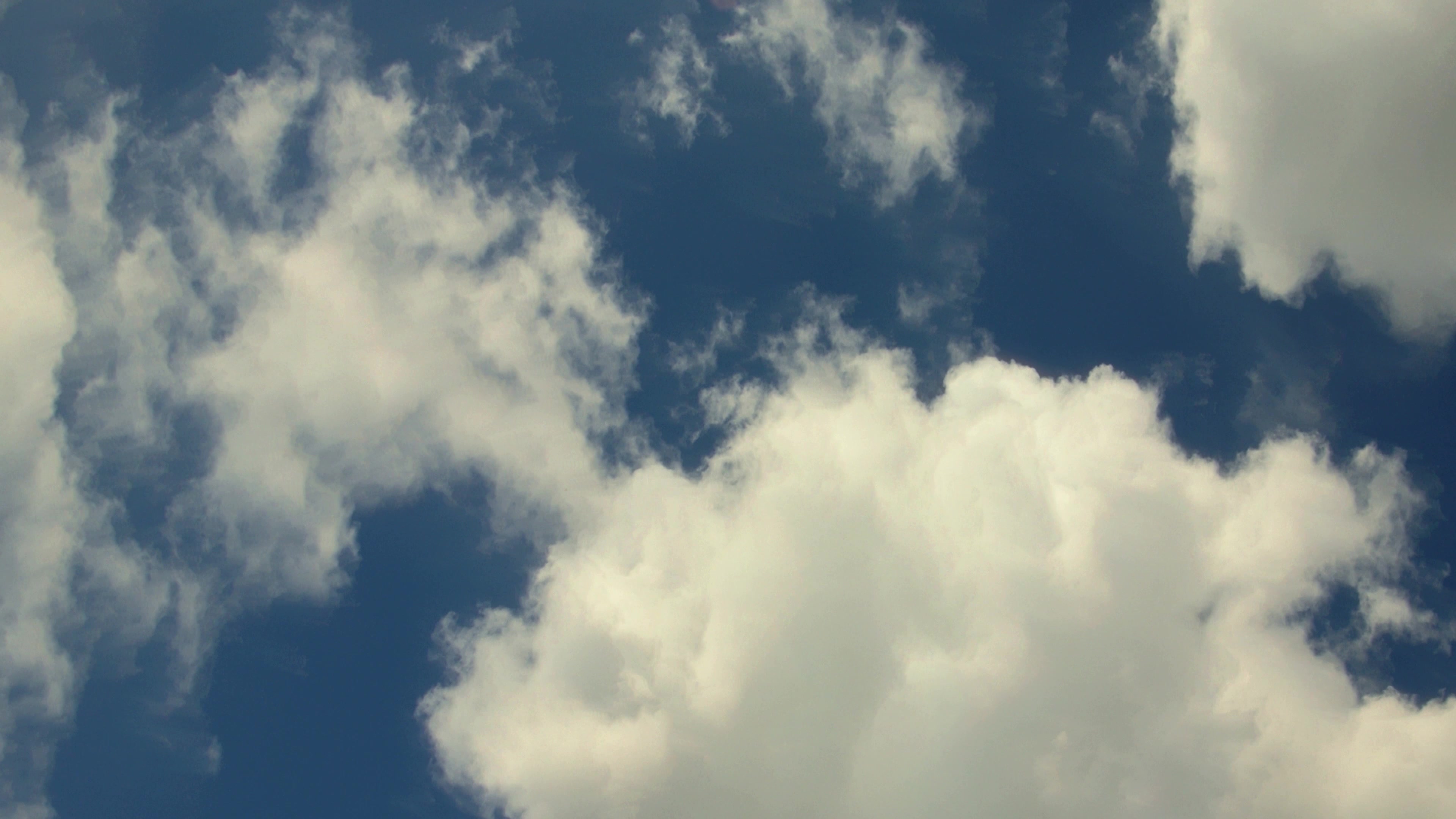 Time-Lapse Clouds Drifting Across Blue Sky 4K Video