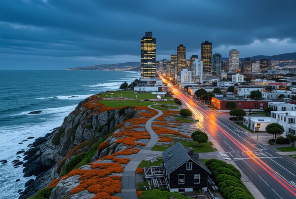 A scenic coastal cityscape with vibrant flowers, tall buildings, and ocean views under a cloudy evening sky.