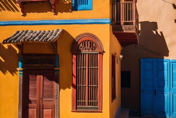Vividly colored building facade with intricate wooden details and vibrant orange, red, and blue accents creating a lively street scene.