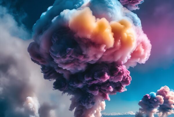A surreal, colorful cloud formation rising vividly against a clear sky, showcasing vibrant hues in nature.