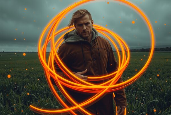 A man in a field with swirling orange light trails, under a cloudy sky, creating a mysterious and dynamic atmosphere.